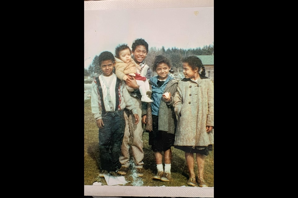Myra Grypuik is being held by her brother, Rudy. The brother on the left of them is Lumario. The two girls on the right are there sisters, Rosita and Marion. This photo was taken before Grypuik was taken by the Dixons.