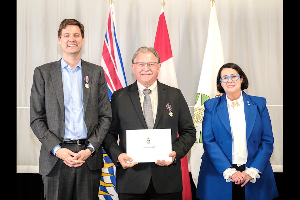 Ken Kalesnikoff (centre) was presented with a King Charles III Coronation Medal by Premier David Eby (L) and Lieutenant Governor Janet Austin (R). (Courtesy Province of B.C.)