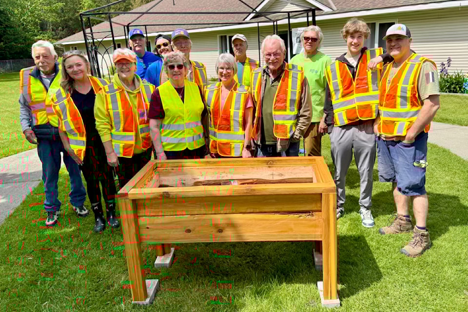 Castlegar Sunrise Rotary members with the new planters they built for  Castleview Care Centre.