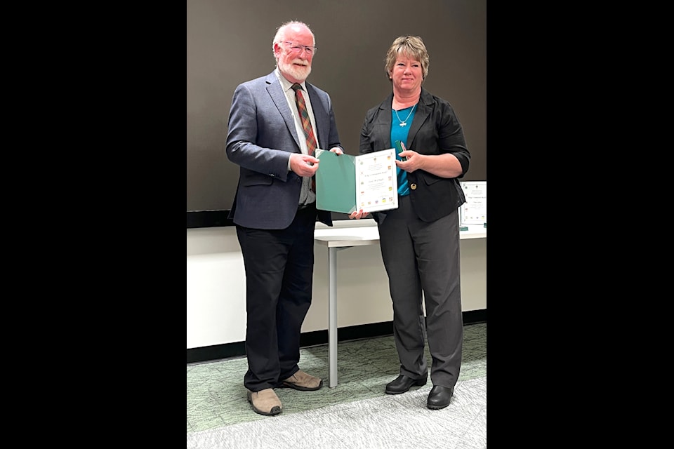 MP Richard Cannings presents Sandi McCreight a King Charles III Coronation Medal at a Castlegar ceremony on March 4.