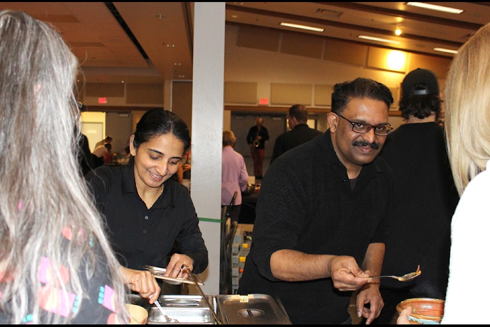 Chefs Sherlin James and James Varghese serve Maple Mirch's prize-winning soup. The Mango Moilee won both the Chef's Choice and People's Choice awards.