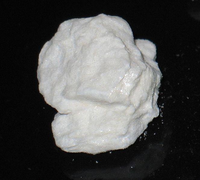 Close up shot of a broken piece of compressed cocaine powder