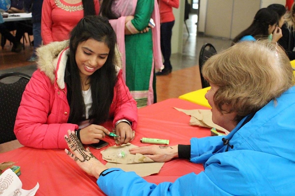 Hartot Kaur, a Selkirk student from India, painted henna tattoos to raise money for the Castlegar Refugee Project at the International Culture Festival on Monday. (Chelsea Novak/Castlegar News)