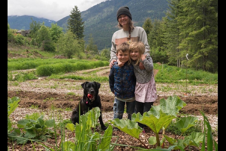 Krista Robson, shown here with her two kids Sawyer and Madyson, has leased farmland in Harrop thanks to the Young Agrarians land matching program. Photo: Ursula Heller