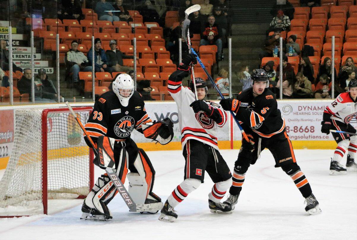 Smoke Eaters defenceman Ethan Willoughby ties up the Centennials forward.