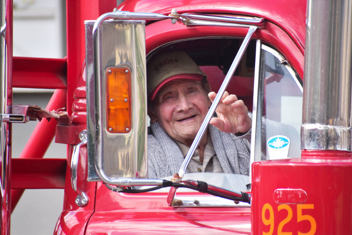 Ray Collins, 96, waves from his Ol Red Mack logging truck during the Billy Barker Days in Quesnel. Collins owned one of the first logging companies in Quesnel, and bought Ol Red new in 1960 with a self loading trailer for $23,000. (Rebecca Dyok photo  Quesnel Observer)