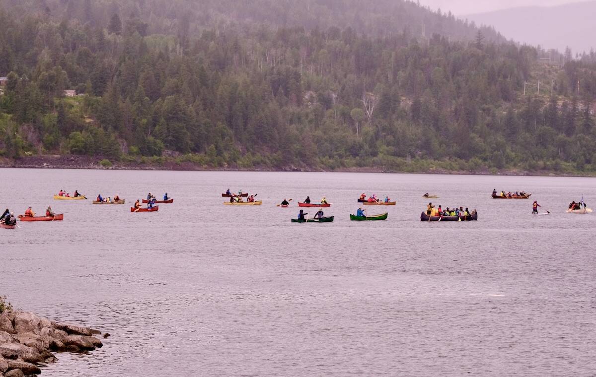 About 20 non-motorized boats, not all shown here, accompanied the Sinixt across the lake. Photo: Bill Metcalfe