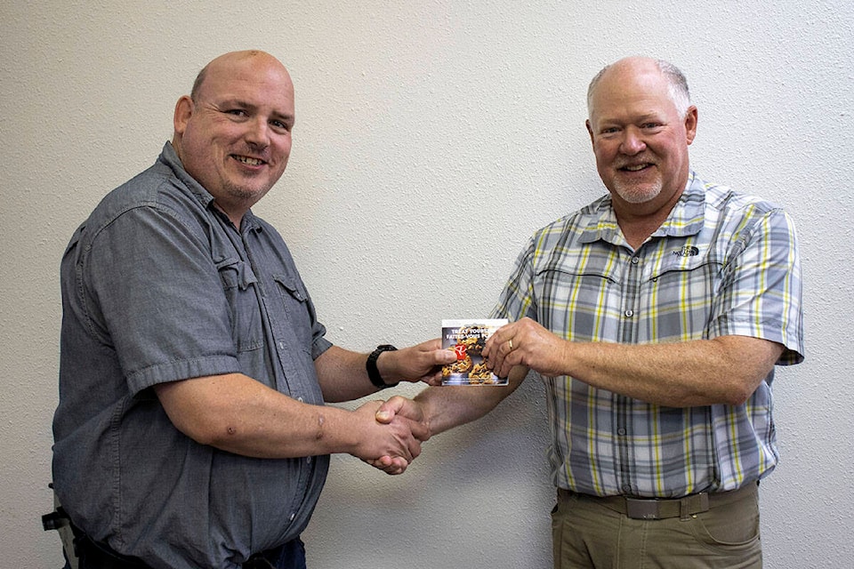 Rob Brennen was the Stettler Independent photo contest winner for the month of July. Presenting Brennan his prize is Stettler Independent Journalist Kevin Sabo. (Black Press News Media)