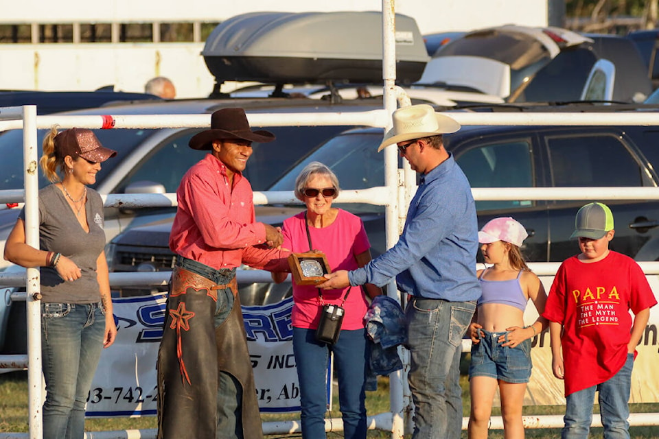 The family of David Chick, one of the founders of the Bullaram, presents Marcos Gloria the high point buckle from the 2023 Bullarama. (Kevin Sabo?Castor Advance)