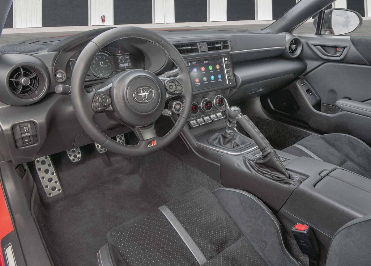 The GR86s interior has a 7.0-inch digital gauge display plus an 8.0-inch touch-screen that replaces the previous generations 7.0-inch version. Note the stick shift, although an automatic transmission is an option. PHOTO: TOYOTA