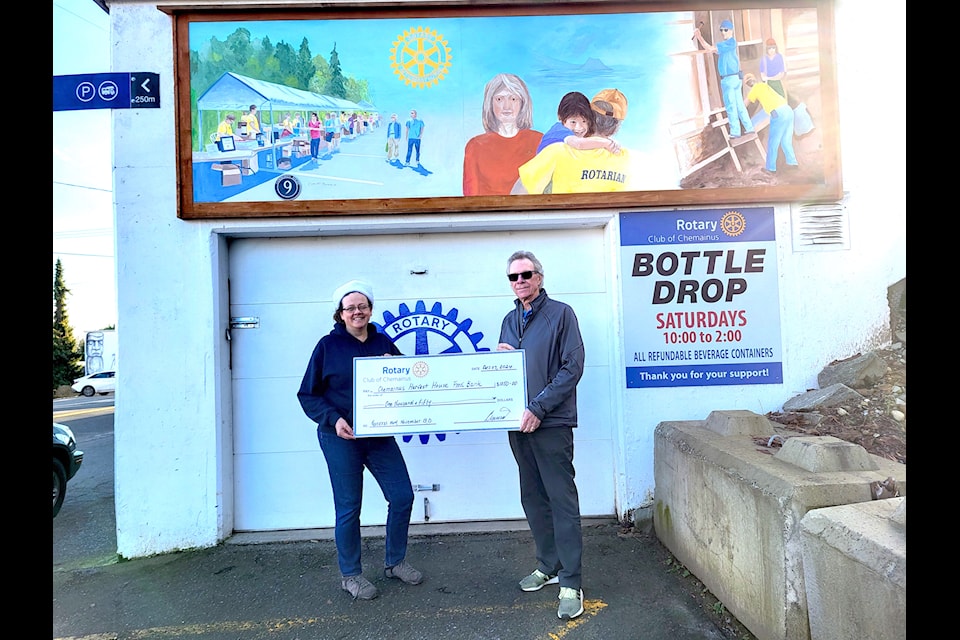 Tom Andrews from the Rotary Club of Chemainus presents a cheque to Emily Holmes of Chemainus Harvest House Food Bank. 