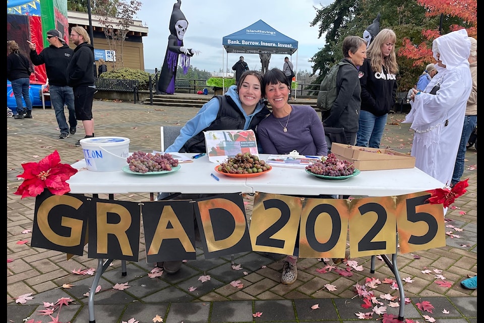 Olivia Laidlaw and her mother Dana Kolosoff sold raffle tickets in drier weather Oct. 26 at Cowichan Fall Fest. Funds raised will go towards the Chemainus Secondary School grad 2025.