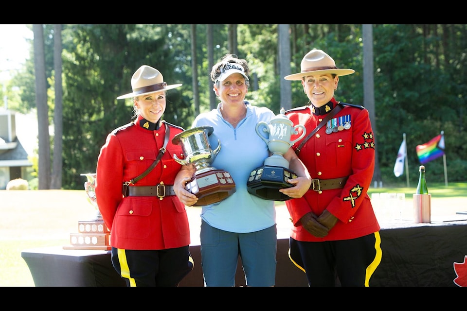 Shelley Stouffer flanked by RCMP officers Const. Monika Terragni (left) and Cpl. Tori Cliffe.