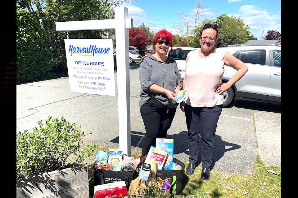 Jennifer "Doc" Morrell (left) from Doc the Barber celebrated 15 years of business in Chemainus with a fundraiser benefiting Harvest House food bank. Emily Holmes, Harvest House coordinator, gratefully received the funds on behalf of the organization.