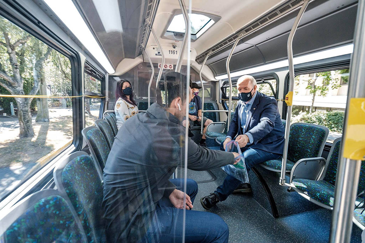 Premier John Horgan offers masks to BC Transit passengers as friendly reminder