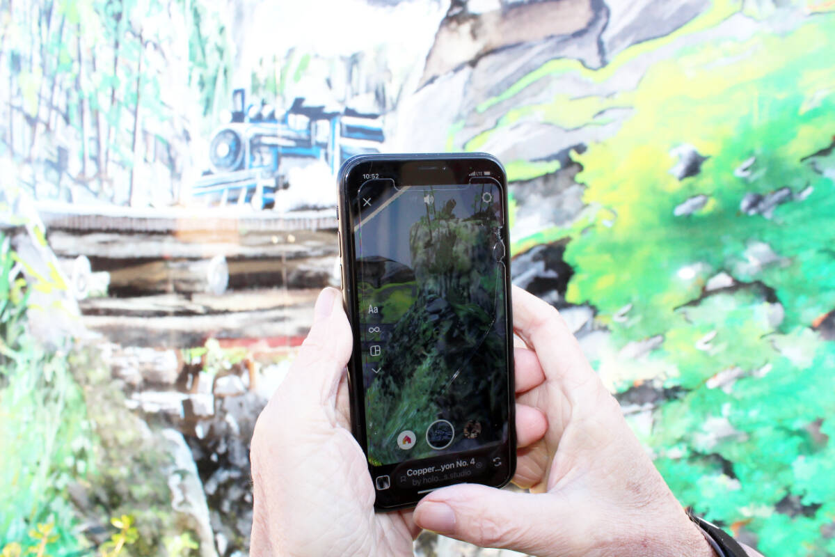 A moving train, rushing waters and other mural features are captured on Tom Andrews phone. Don Bodger photo