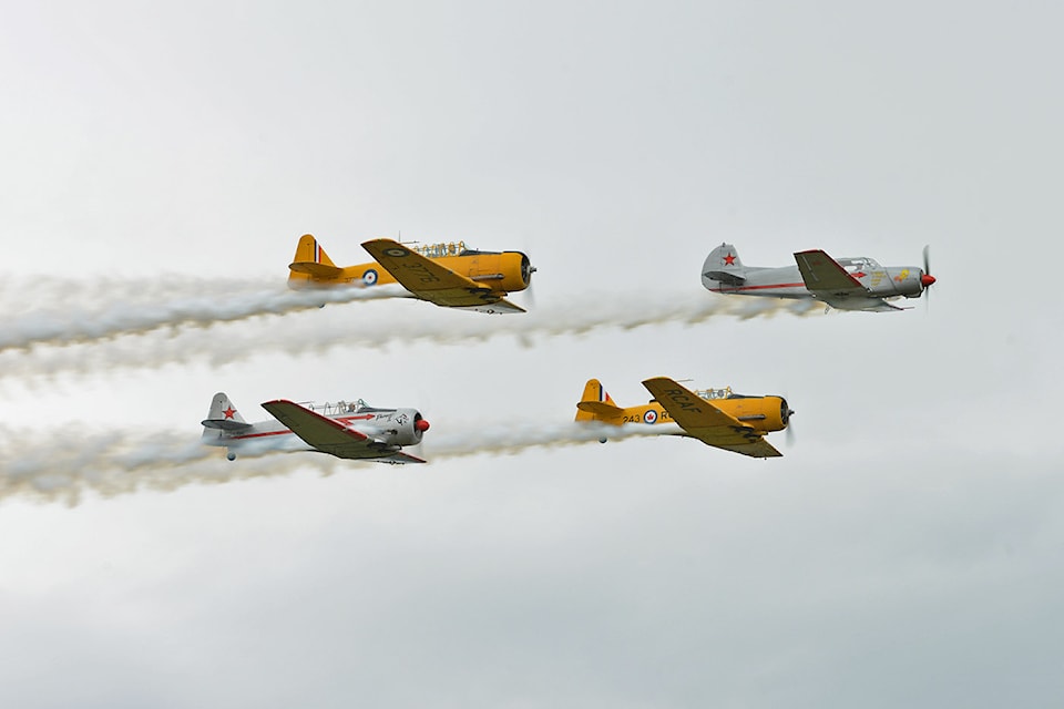 Drew and David Watson, known as Yellow Thunder, plus John and Richard Mrazek (in grey airplanes) fly in formation during Chilliwack Flight Fest on Sunday, Aug. 18, 2024. 