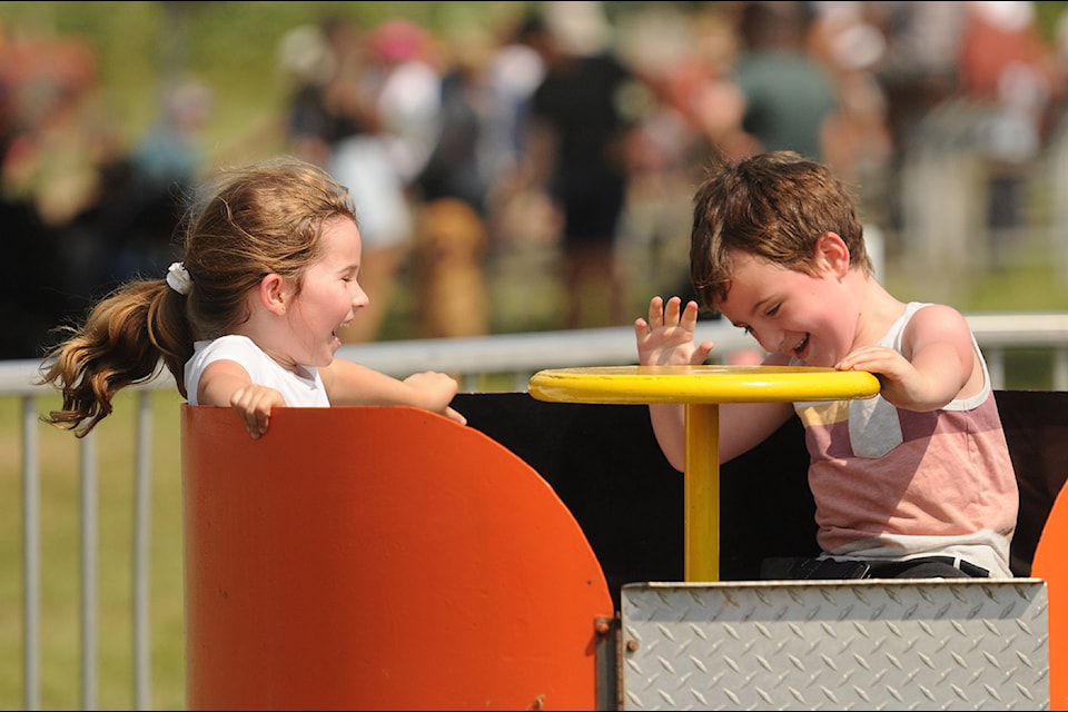 Friends Avianna Schiazza and Pierson Thody, both 5, spin around on a ride during the 152nd annual Chilliwack Fair on Saturday, Aug. 10, 2024.