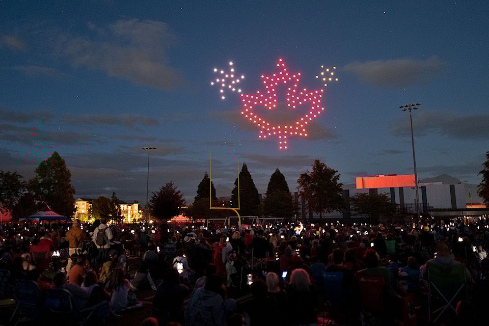 Thousands of people watch a nighttime drone show at Exhibition field during Chilliwack's Canada Day celebrations on Monday, July 1, 2024.