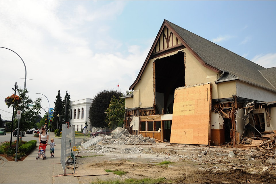 A stained glass window, sandwiched between pieces of plywood, is seen leaning up against the sanctuary at Cheam View United Church in Chilliwack as crews continue to demolish the site on Wednesday, July 17, 2024. (Jenna Hauck/ Chilliwack Progress)