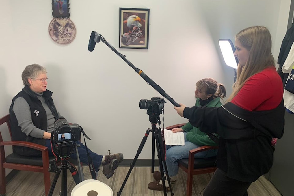Dori Somerset (left) is interviewed G.W. Graham student Hope Chatry as fellow student Emma Neilsen holds a boom pole while filming documentary 'Hope Through Struggle - The Story of the Pantry' at the Chilliwack Salvation Army. 
