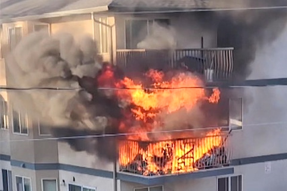 Flames shoot from second floor balcony of apartment. (Farooque Syed photo)