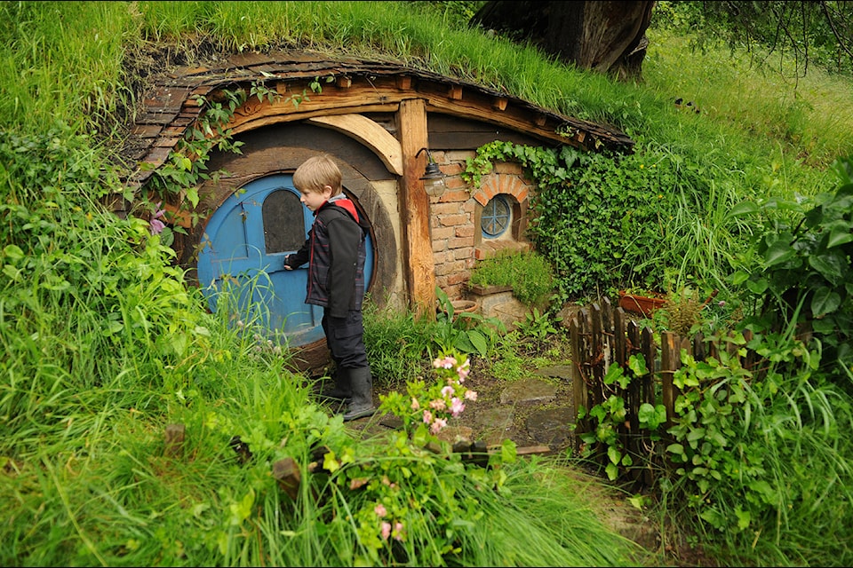 Zayne Les, 5, opens the door to a hobbit house built by Chilliwack resident Jacob Hegeman during the Ryder Lake Ramble on Saturday, June 15, 2024.