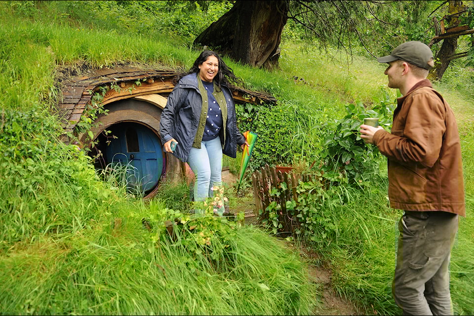Jacob Hegeman (right) chats with visitors outside the hobbit house he built during the Ryder Lake Ramble on Saturday, June 15, 2024.
