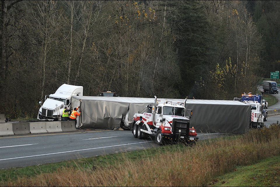 A trailer that landed across Highway 1, east of Annis Road in Chilliwack, is rotated 90 degrees to allow eastbound semis through in the westbound lane following an early-morning collision on Friday, Nov. 8, 2024.