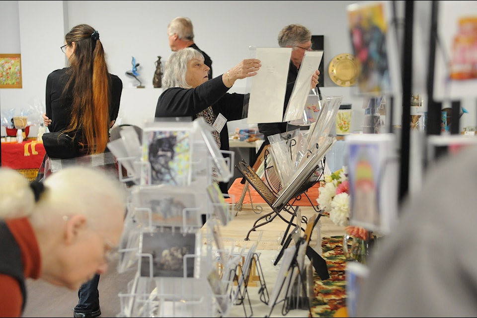 People check out some of the items for sale at the Golden Palette Club’s annual fall art show and sale at Cultus Lake Community Hall on Saturday, Oct. 5, 2024.