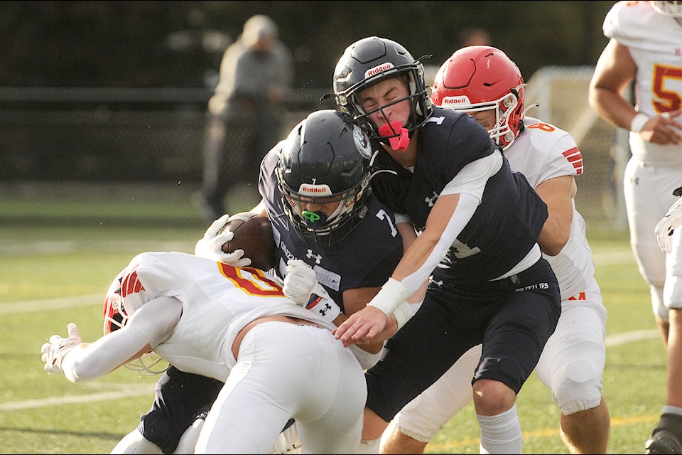 G.W. Graham's Denver Adam (7) is tackled by Joel Muller of W.J. Mouat during a game at Exhibition Field in Chilliwack on Friday, Oct. 11. 