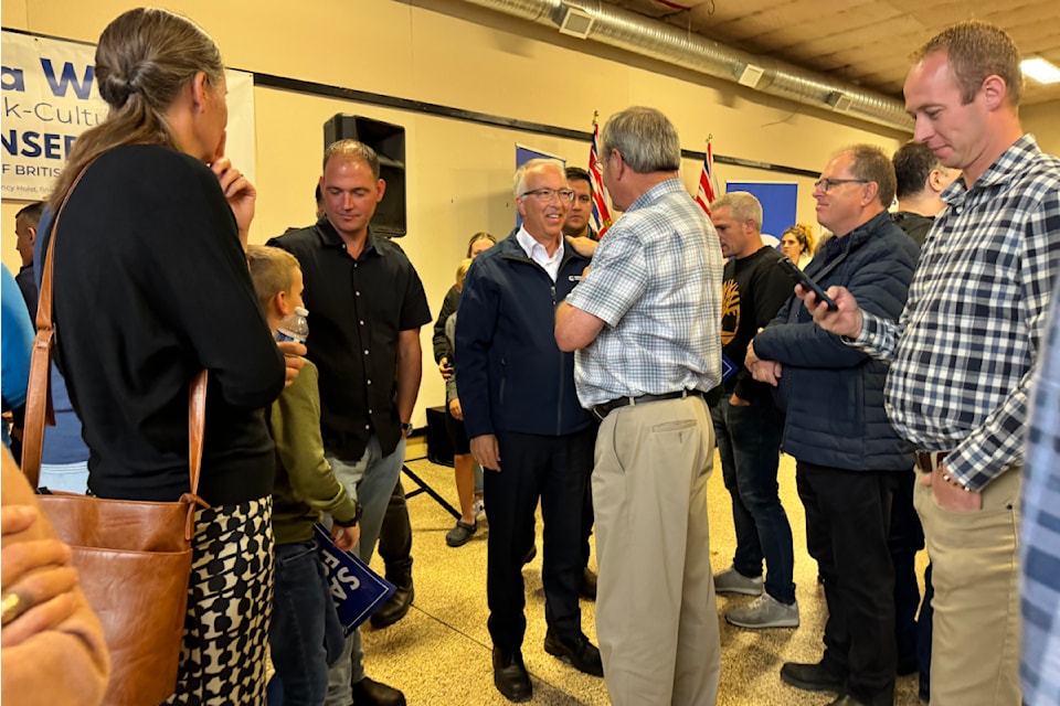 B.C. Conservative leader John Rustad speaks with former B.C. solicitor-general John Les at a meet-and-greet along the campaign trail in Chilliwack on Sept. 28. 