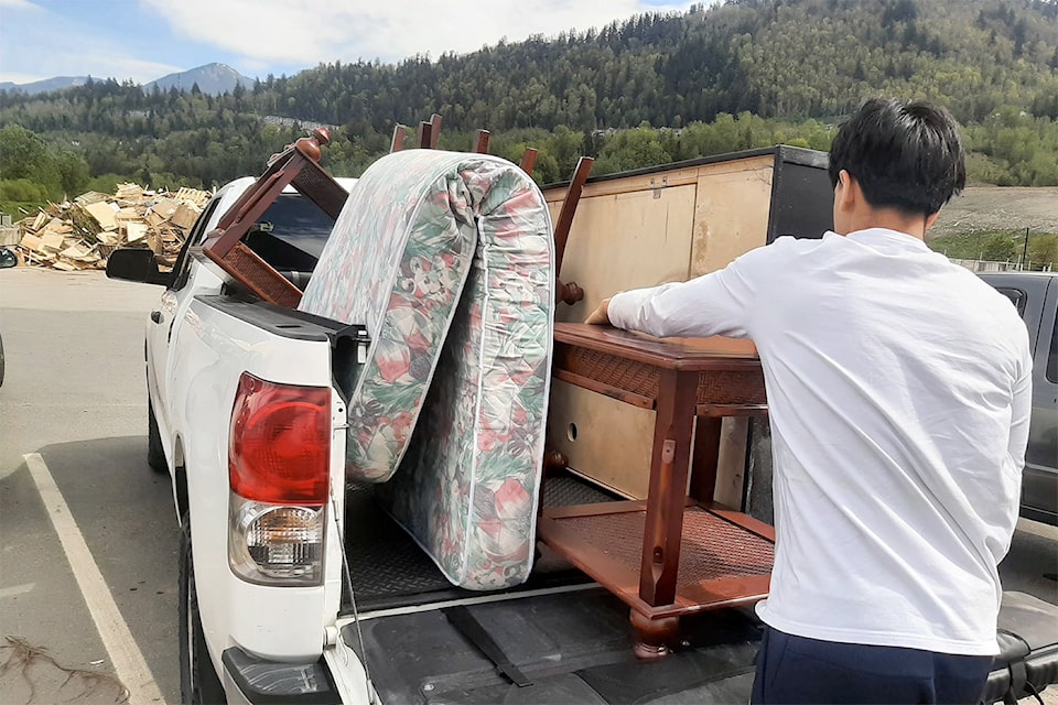 A volunteer with Streams Foundation Canada unloads a truck full of items at the Bailey Sanitary Landfill during the City of Chilliwack's Residential Large Item Pick Up program in the spring of 2024. (Streams Foundation Canada/ Facebook)