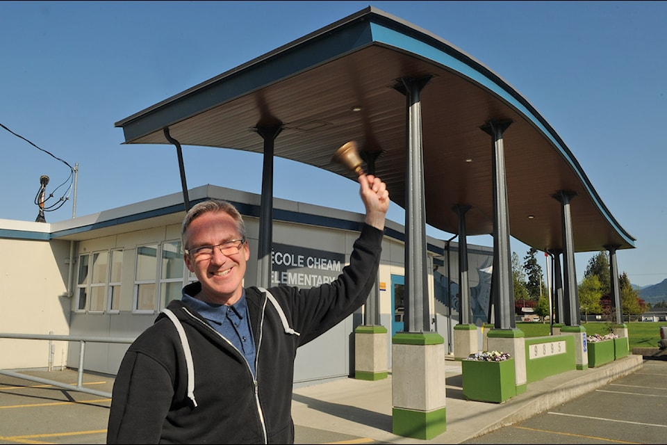 Cheam Elementary School principal Iain Gardner holds the school's defunct handbell which predates the 73-year-old building on April 24, 2025.