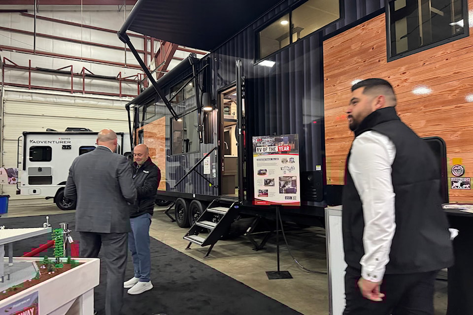 Visitors to the 30th annual Earlybird RV Show and Sale at Abbotsford's Tradex check out the 'RV of the Year' a 2025 Cedar Creek Cottage destination trailer, made by Forest River on Friday, Feb. 21, 2025. 