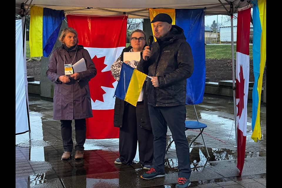 Oleksandr Vorobets, co-founder of RIY Vancouver, speaks as organizers Maryanna Klymtsiv and Iryna Kobets look on during the candlelight vigil at Central Community Park on Sunday, Feb. 23, 2025. 