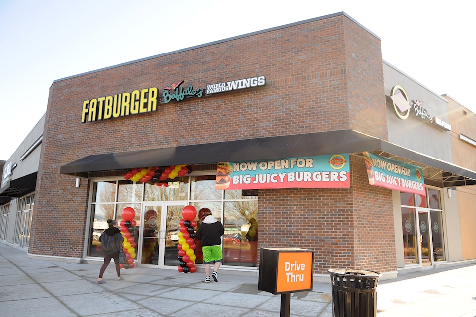 People are seen outside Fatburger on opening day in Chilliwack on Friday, Jan. 17, 2025.