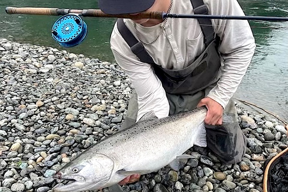 Fishing guide Dawson Kallevig with a summer chinook he caught on the Vedder River near the train bridge. 