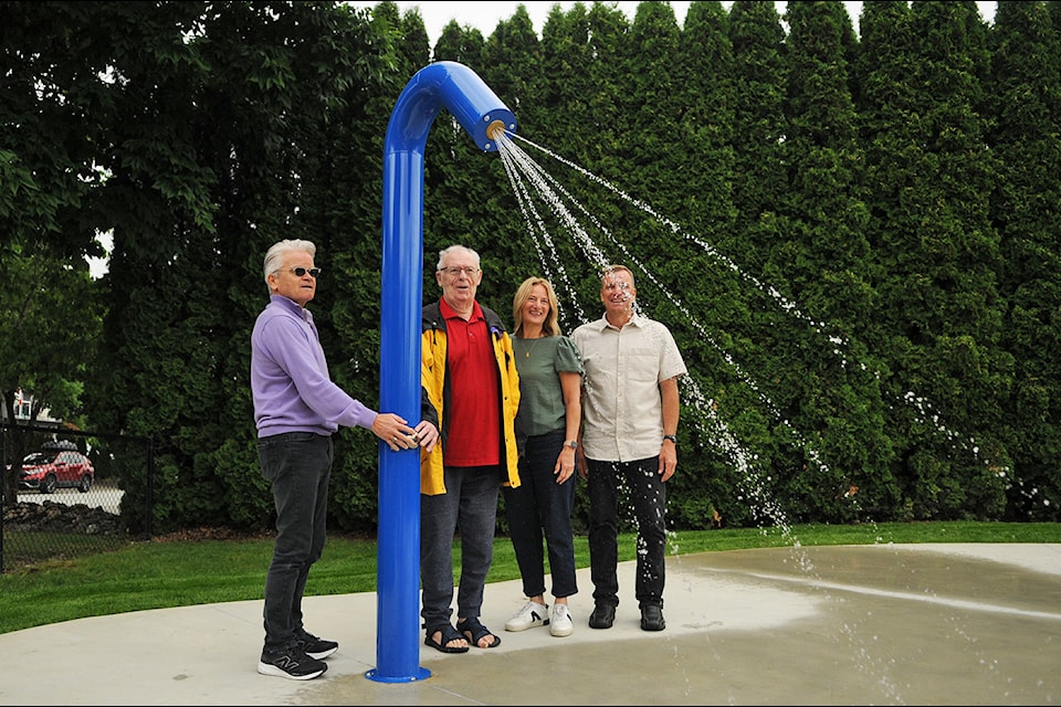 Rodney Philippson (red shirt) turned the water on at Philippson Family Park, officially opening the new spray zone there on Friday, June 27, 2025. He is pictured with City of Chilliwack mayor and councillors (from left) Ken Popove, Nicole Huitema Read and Harv Westeringh.