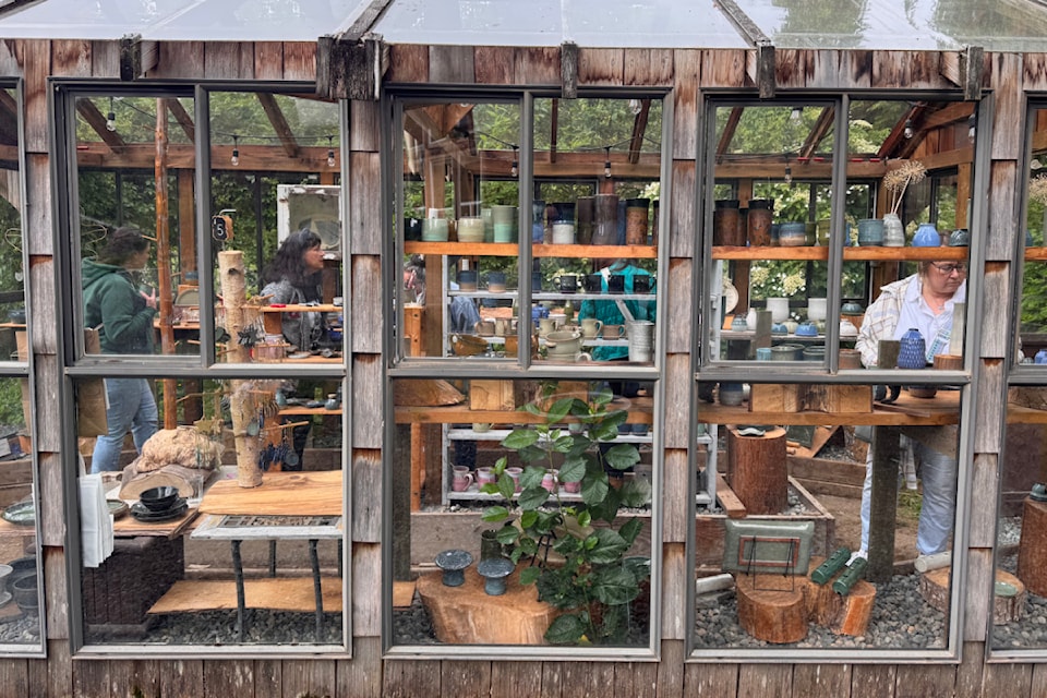 Guests check out the offerings at Autumn Leaf Pottery on Voight Road, as part of the Ryder Lake Ramble on June 14. 