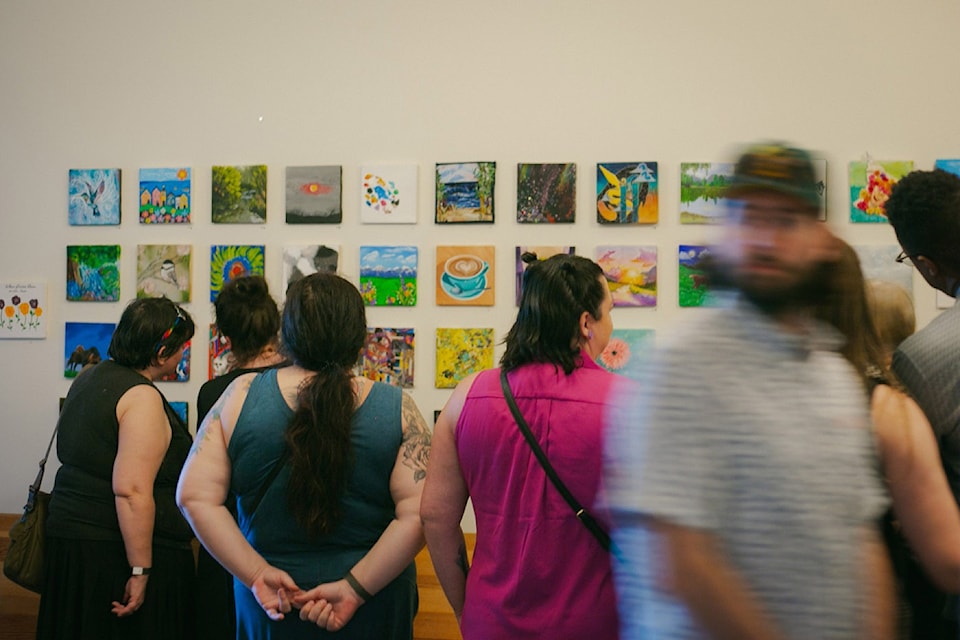People look at the pieces on display during the inaugural Anonymous Art Show in Chilliwack in 2024.