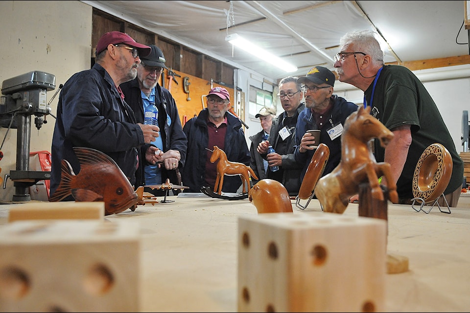 Members of the Chilliwack Men's Shed and visitors chat during an open house on May 31, 2025. (Jenna Hauck/ Chilliwack Progress)
