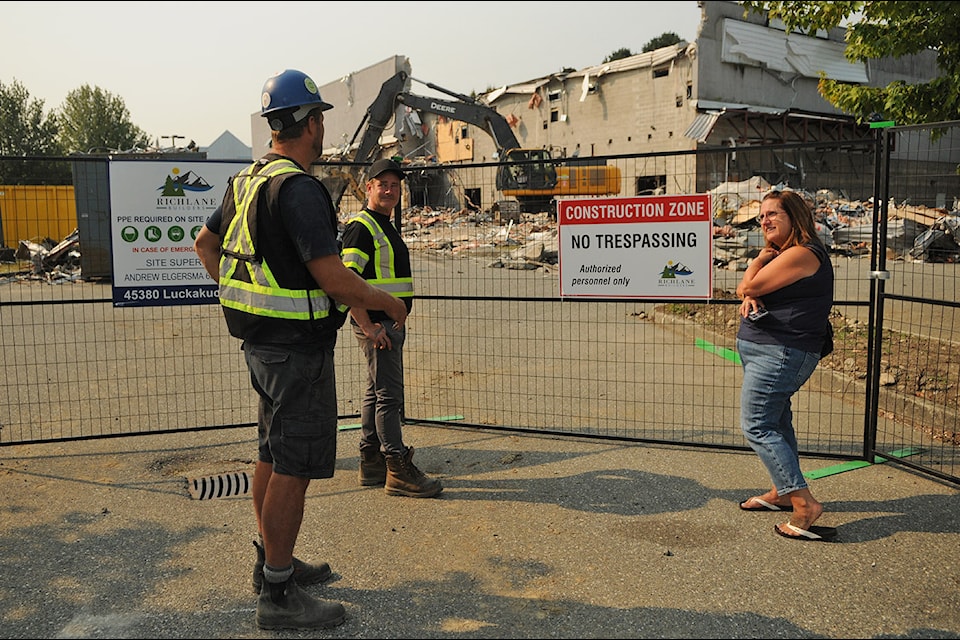 From left: Andrew Elgersma with Richlane Builders, Ross Delaney with Universal Contracting, and former owner of Cottonwood 4 Cinemas, Cathy Rayner, chat as the building on Luckakuck Way was being demolished on Thursday, Sept. 4, 2025. 