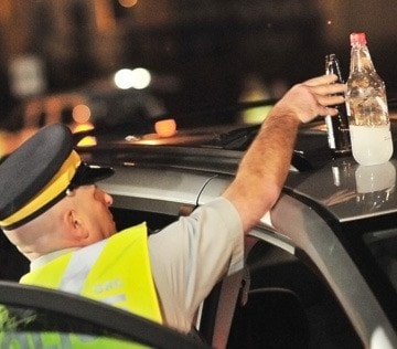 Cpl. Lorne Lecker removes open liquor from a minivan.
BOAZ JOSEPH / THE LEADER