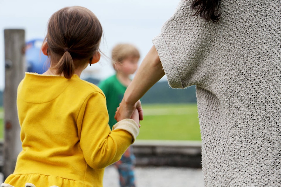 10653975_web1_Child-holding-mom-hand-at-park.SL.31