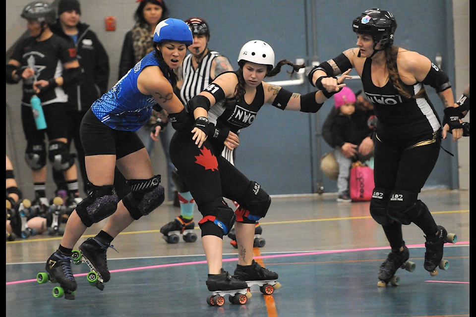 From right, Hayley Lennard (aka Rapainzel) and Sierra Therrien (Frank’ N Hurter) of Chilliwack’s NWO Roller Girls try to block a jammer during a game against Nanaimo’s Harbour City Rollers during the local flat-track roller derby league’s annual Daze of Derby event on Nov. 9, 2019 at the Chilliwack Landing Sports Centre. (Jenna Hauck/ The Progress)