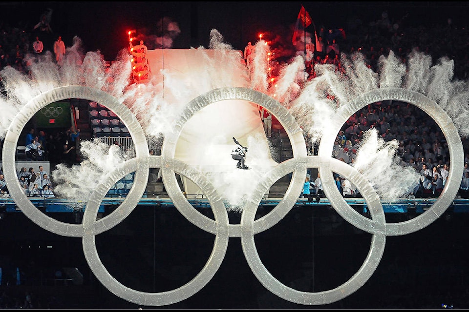 Vancouver snowboarder Johnny Lyall flies through the Olympic rings to kick off the Opening Ceremonies for the 2010 Winter Games at BC Place on Feb. 12, 2010. (Jenna Hauck/ Black Press file)