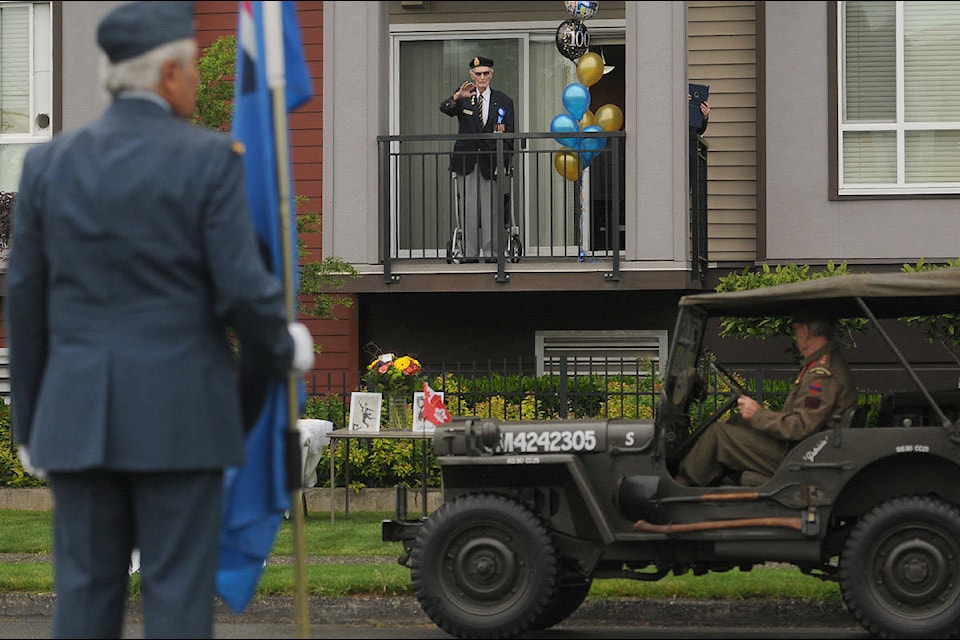 About 50 vehicles, including some vintage military ones, drove past the home of Gordon Norrish on Spadina Avenue to wish him a happy 100th birthday on Saturday, May 16, 2020. (Jenna Hauck/ The Progress)