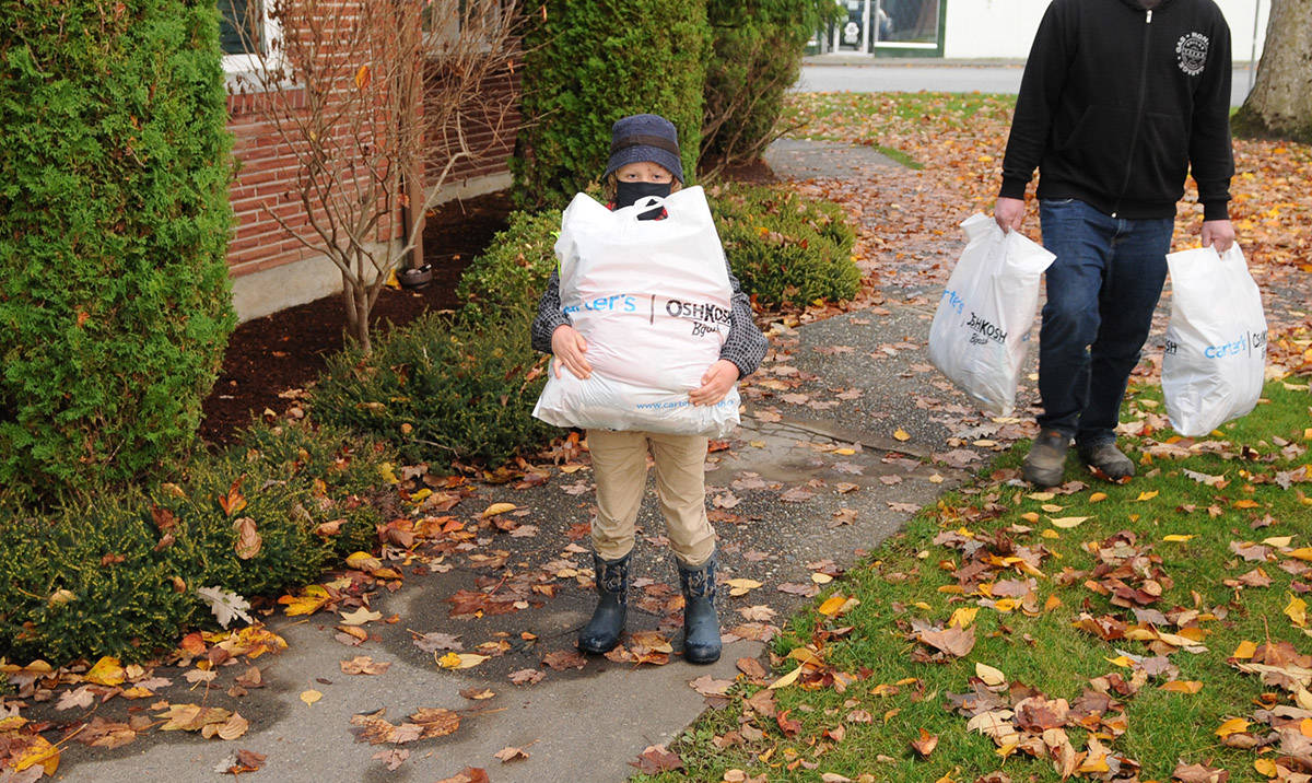 Eight-year-old Wyatt Desilets with 6th Chilliwack Beavers helps deliver nearly $500 worth of pyjamas to Cyrus Centre on Thursday, Nov. 5. (Jenna Hauck/ Chilliwack Progress)