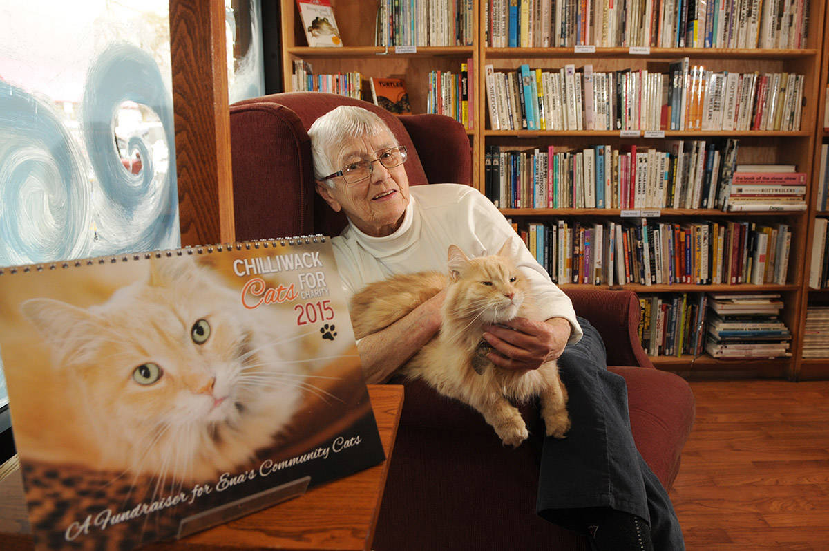 Nietzsche, the ginger cat who worked at The Book Man, poses for a photo with Ena Vermerris on Dec. 4, 2014. Nietzsche died on Monday, Feb. 22, 2021. (Jenna Hauck/ Chilliwack Progress file)